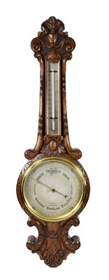 Lot 427 - <> A Carved Oak Aneroid Barometer, retailed by E.Lennie, Optician, Edinburgh, circa 1910, case with