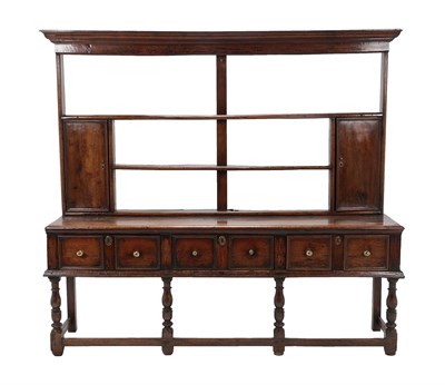 Lot 432 - An Early 18th Century Open Dresser and Rack, with three fixed shelves above two cupboard doors, the