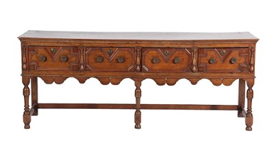 Lot 435 - A Late 17th Century Oak Dresser, the moulded top above four geometric moulded drawers between...