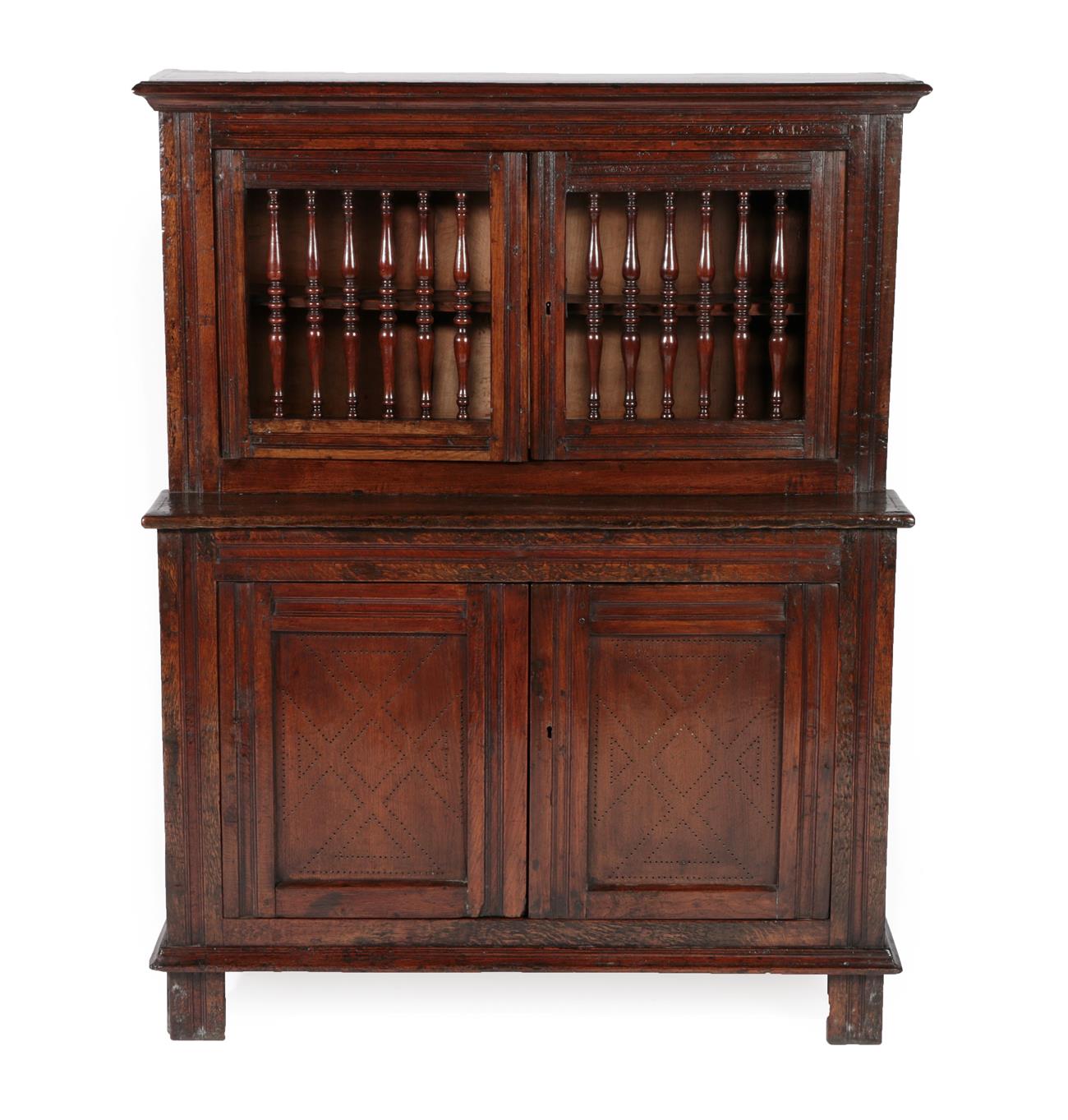 Lot 441 - An 18th Century Joined Oak Food Cupboard, probably North Wales, the upper section with turned...
