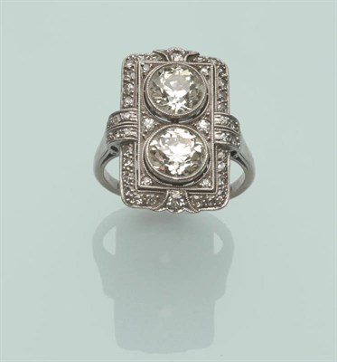 Lot 512 - A French Art Deco Ring, two old brilliant cut diamonds in an oblong diamond set surround, in...