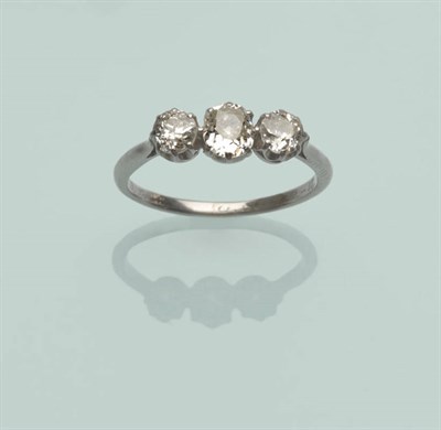 Lot 513 - A Diamond Three Stone Ring, the graduated old cut diamonds in white claw settings to a tapered...