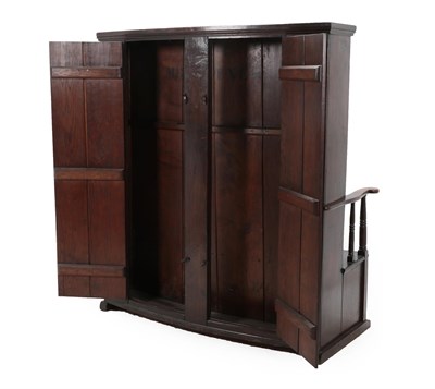 Lot 453 - A 20th Century Joined Oak Settle, of boarded construction, the curved back section above a...