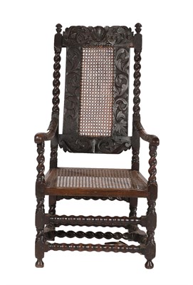 Lot 458 - ^ A Late 17th Century Carved Walnut Open Armchair, with cane back and seat, the carved top rail...