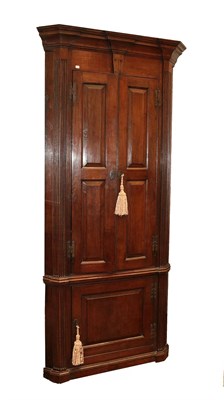 Lot 468A - An 18th Century Style Oak Free-Standing Corner Cupboard, the breakfront moulded cornice above...