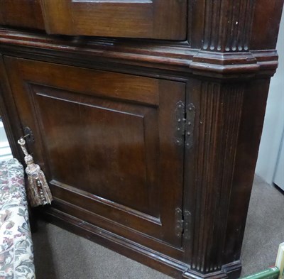 Lot 468 - An 18th Century Style Oak Free-Standing Corner Cupboard, the breakfront moulded cornice above...