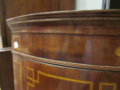 Lot 502 - A George III Mahogany and Marquetry Inlaid Bowfront Corner Cupboard, circa 1780, the frieze...