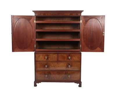 Lot 504 - {} A George III Mahogany and Crossbanded Linen Press, early 19th century, the bold cornice...