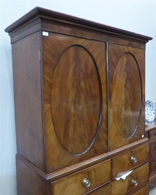 Lot 504 - {} A George III Mahogany and Crossbanded Linen Press, early 19th century, the bold cornice...