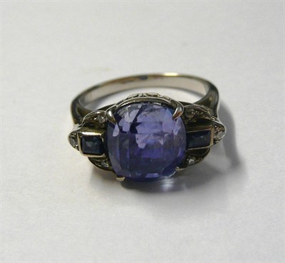 Lot 520 - An Art Deco Sapphire and Diamond Ring, the mixed cut cushion shaped sapphire within a sapphire...