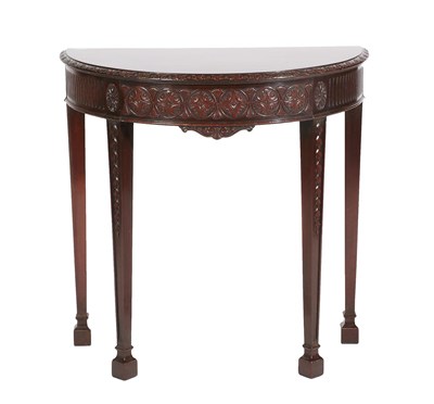 Lot 538 - A Late Victorian Carved Mahogany D Shape Table, with carved border above a rosette and fluted...