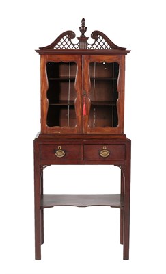 Lot 556 - ~ A George III Glazed Mahogany Display Cabinet, late 18th century, the fret carved swan neck...