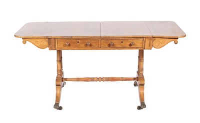 Lot 569 - ~ A Regency Rosewood Sofa Table, early 19th century, the two drop leaves with pivoting scrolled...