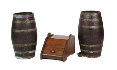 Lot 579 - ~ Two Oak Barrels, of staved construction, each with six brass studded straps, 26cm by 20cm by...