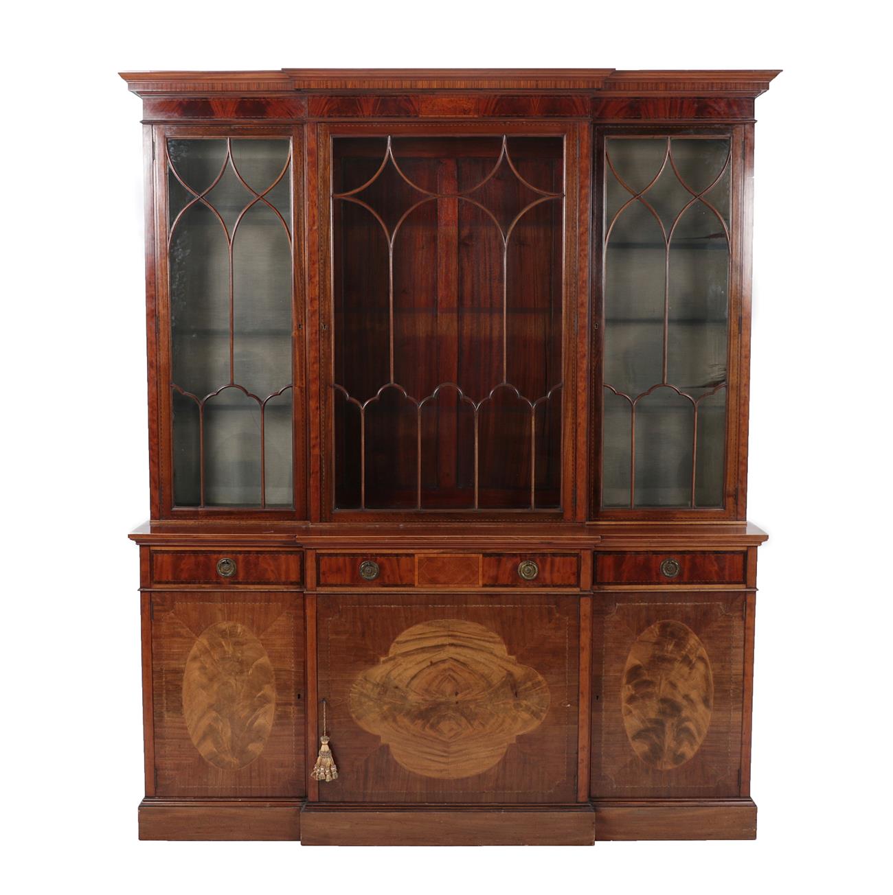 Lot 593 - A Mahogany and Satinwood Banded Breakfront Bookcase, stamped Warings, late 19th century, with three