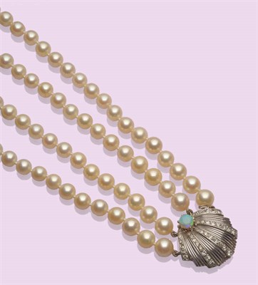 Lot 528 - A Two Row Cultured Pearl Necklace, the 49:51 knotted pearls graduate to a clasp in the form of...