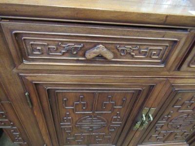 Lot 603 - An Early 20th Century Chinese Hardwood Side Cabinet, the top section with moulded and scrolled...
