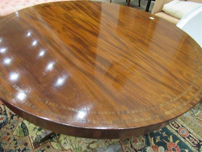 Lot 615 - {} A Regency Mahogany and Rosewood Circular Dining Table, early 19th century, the fliptop above...