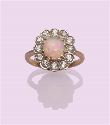 Lot 532 - An Early 20th Century Opal and Diamond Cluster Ring, the cushion shaped cabochon opal in a...