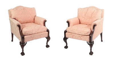 Lot 649 - A Pair of Early 20th Century Carved Mahogany Armchairs, recovered in floral pink fabric, with squab