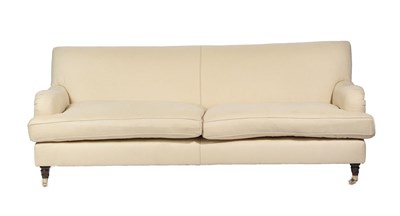 Lot 657 - ~ A Pair of Feather-Filled Three-Seater Sofas, modern, covered in cream calico-type fabric,...