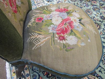 Lot 658 - ~ A Victorian Walnut Nursing Chair, circa 1870, covered in floral needlework and green velvet...