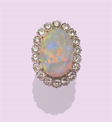 Lot 534 - An Opal and Diamond Cluster Ring, the oval cabochon opal within a border of round brilliant cut...