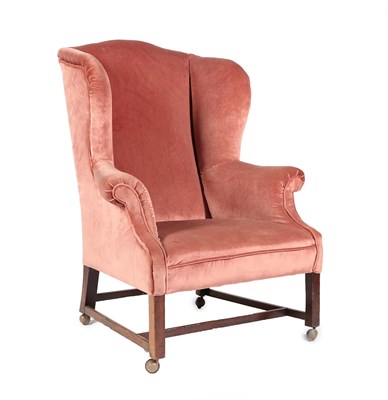 Lot 669 - ~ A Late George III Mahogany Framed Wing-Back Armchair, early 19th century, recovered in pink...