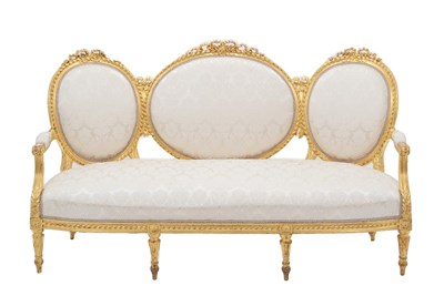Lot 683 - {} A Victorian Giltwood Three-Seater Sofa, in Louis XV style, covered in floral cream damask,...