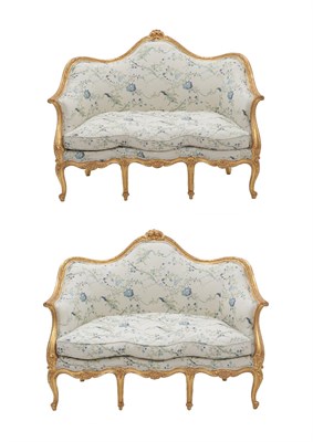 Lot 685 - {} A Pair of Louis XV Style Giltwood and Gesso Two-Seater Canapes, late 19th/early 20th...