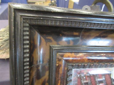 Lot 693 - A Late 19th Century Flemish Style Tortoiseshell and Ebonised Wall Mirror, the bevelled glass...