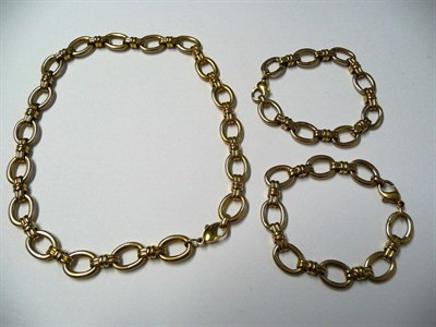 Lot 537 - A 9 Carat Gold Necklace and Two Matching Bracelets, of large loop links connected by double bar...