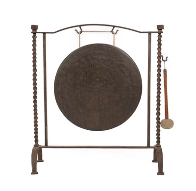 Lot 695 - ~ An Early 20th Century Cast Iron Dinner Gong, with spiral turned supports suspending a brass gong