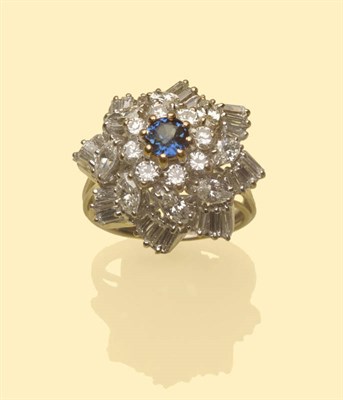 Lot 548 - A Sapphire and Diamond Cluster Ring, the round sapphire within a border of round brilliant cut...