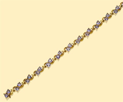 Lot 551 - A Tanzanite and Diamond Bracelet, thirteen articulated swirl links each set with a pair of...