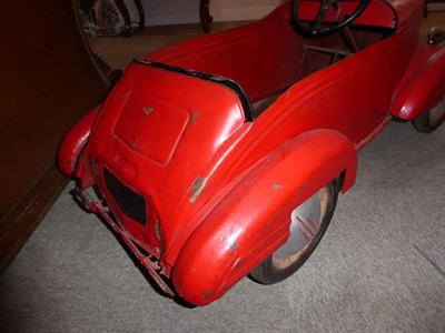 Lot 40 - A 1920's/30's Metal Bodied and Red Painted Child's Pedal Car, with stylised mascot grille and...