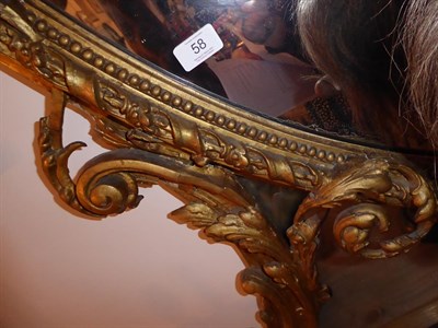 Lot 58 - A Large Louis XVI Style Giltwood and Gesso Overmantel Mirror, 19th century, the oval mirror...