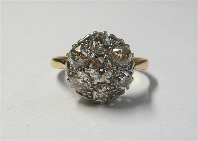 Lot 560 - A Diamond Cluster Ring, seven old cut diamonds in a white claw setting, to a yellow tapered...