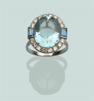Lot 564 - An 18 Carat White Gold Aquamarine, Sapphire and Diamond Cluster Ring, the oval cut aquamarine...