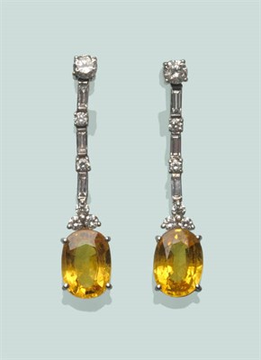 Lot 573 - A Pair of 18 Carat White Gold Yellow Sapphire and Diamond Drop Earrings, round brilliant cut...