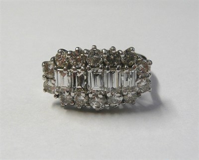 Lot 577 - An 18 Carat White Gold Diamond Cluster Ring, five graduated baguette cut diamonds within a...