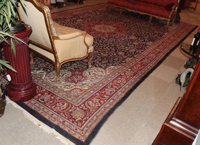 Lot 331 - An Indian Carpet The deep indigo field of vines around a crimson medallion framed by ivory...