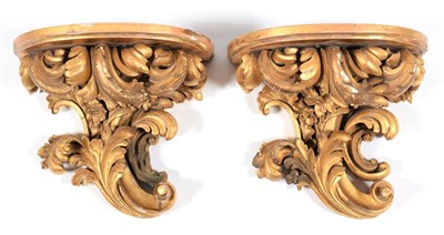 Lot 347 - A Pair of Carved Giltwood and Gesso Wall Brackets, 19th century, with demi-lune plateaux on...