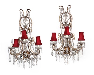 Lot 348 - A Pair of Gilt Metal and Cut Glass Three-Light Wall Lights, in 18th century style, with scroll...