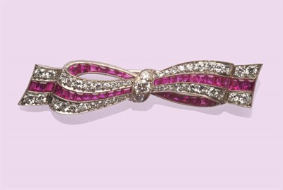 Lot 590 - An Art Deco Ruby and Diamond Bow Brooch, calibré cut rubies and round brilliant cut and...