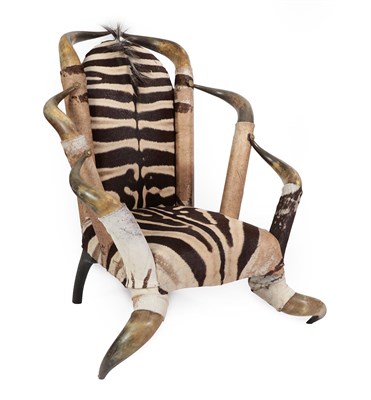 Lot 382 - A 20th Century Cow Horn Armchair, recovered in zebra skin, with leather covered arm supports...