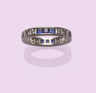 Lot 592 - A Sapphire and Diamond Eternity Ring, by Cartier, a series of three step cut sapphires and...