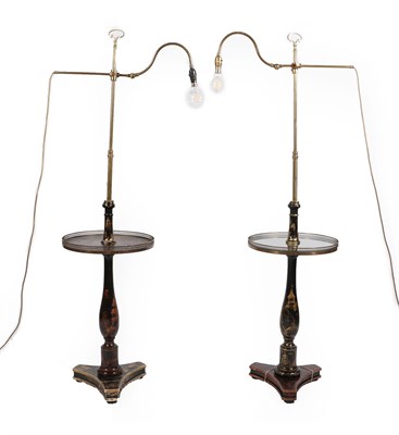 Lot 409 - Two Edwardian Japanned and Brass Standard Lamps, early 20th century, each with adjustable pole...
