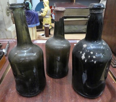 Lot 16 - A tray of 18th and 19th century glass bottles including a string neck mallet wine bottle, seal...
