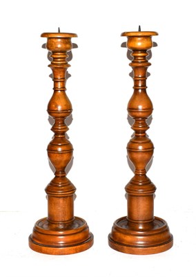Lot 29 - A pair of modern turned wooden pricket sticks, 43cm high